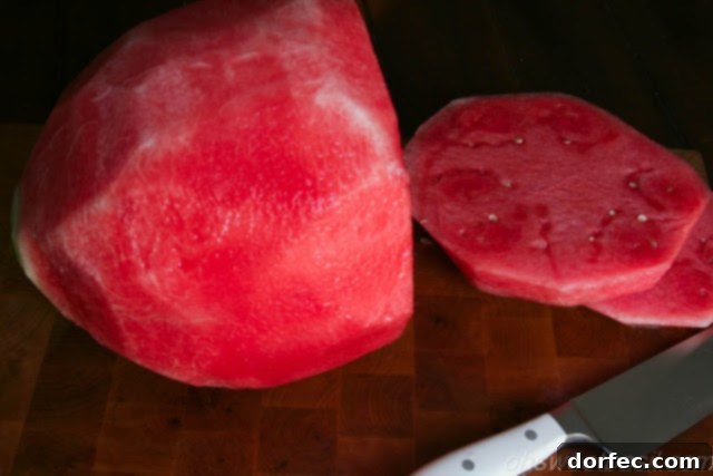 Watermelon rind removed, now slicing into rings