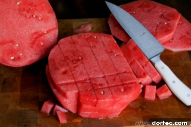 Watermelon rings stacked and ready for cubing