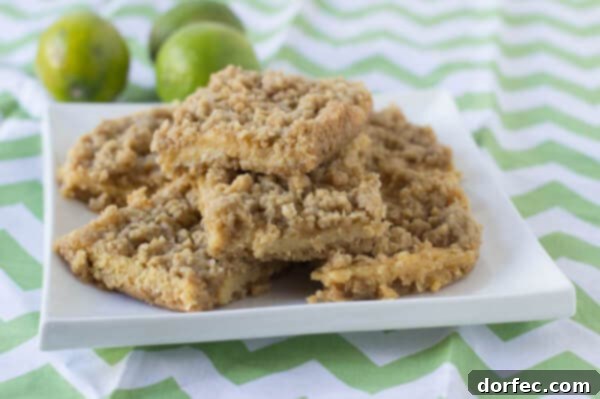 Key Lime Crumble bars featuring a buttery crust and topping with a creamy, tart lime center. A perfect summer dessert from ohsweetbasil.com