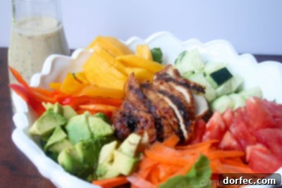 Close-up of Teriyaki Chicken Salad showcasing avocado and colorful peppers
