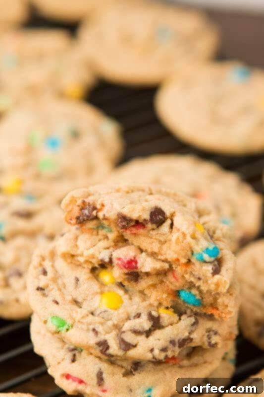 Stack of freshly baked Peanut Butter Chocolate Chip M&M Cookies on a plate, ready to be enjoyed.