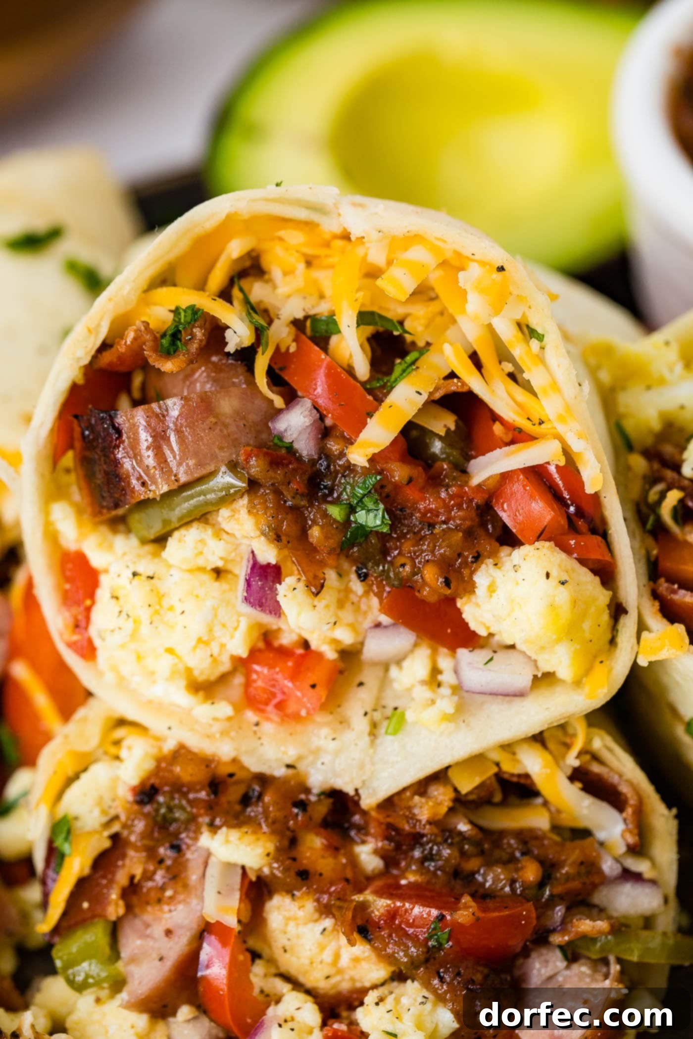 An apple chicken sausage burrito stuffed full of sausage, eggs, peppers, and cheese.