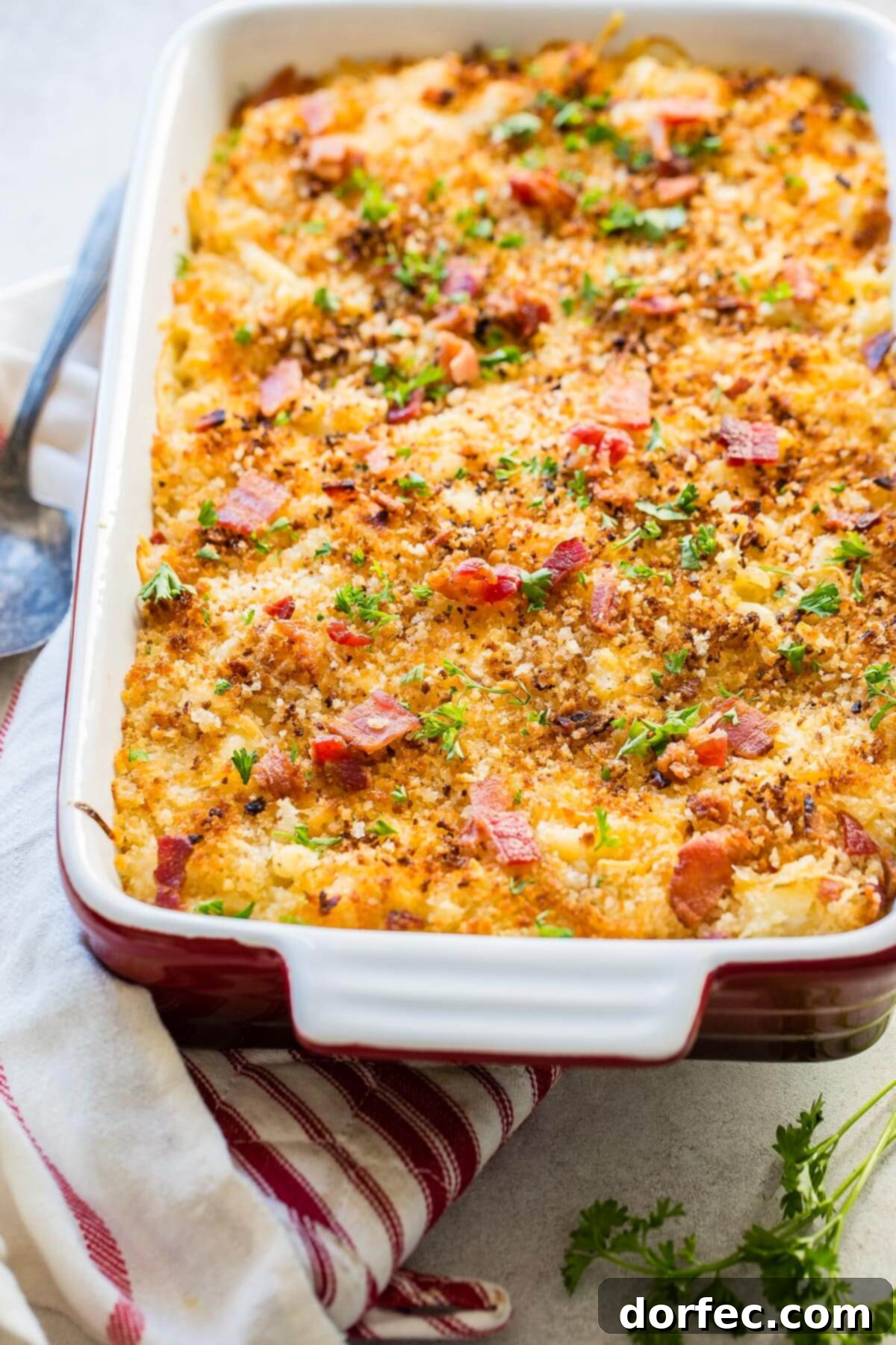 Loaded Chicken Bacon Ranch Macaroni and Cheese 7 A golden pan of chicken bacon mac and cheese bake resting on a tea towel, ready to be served