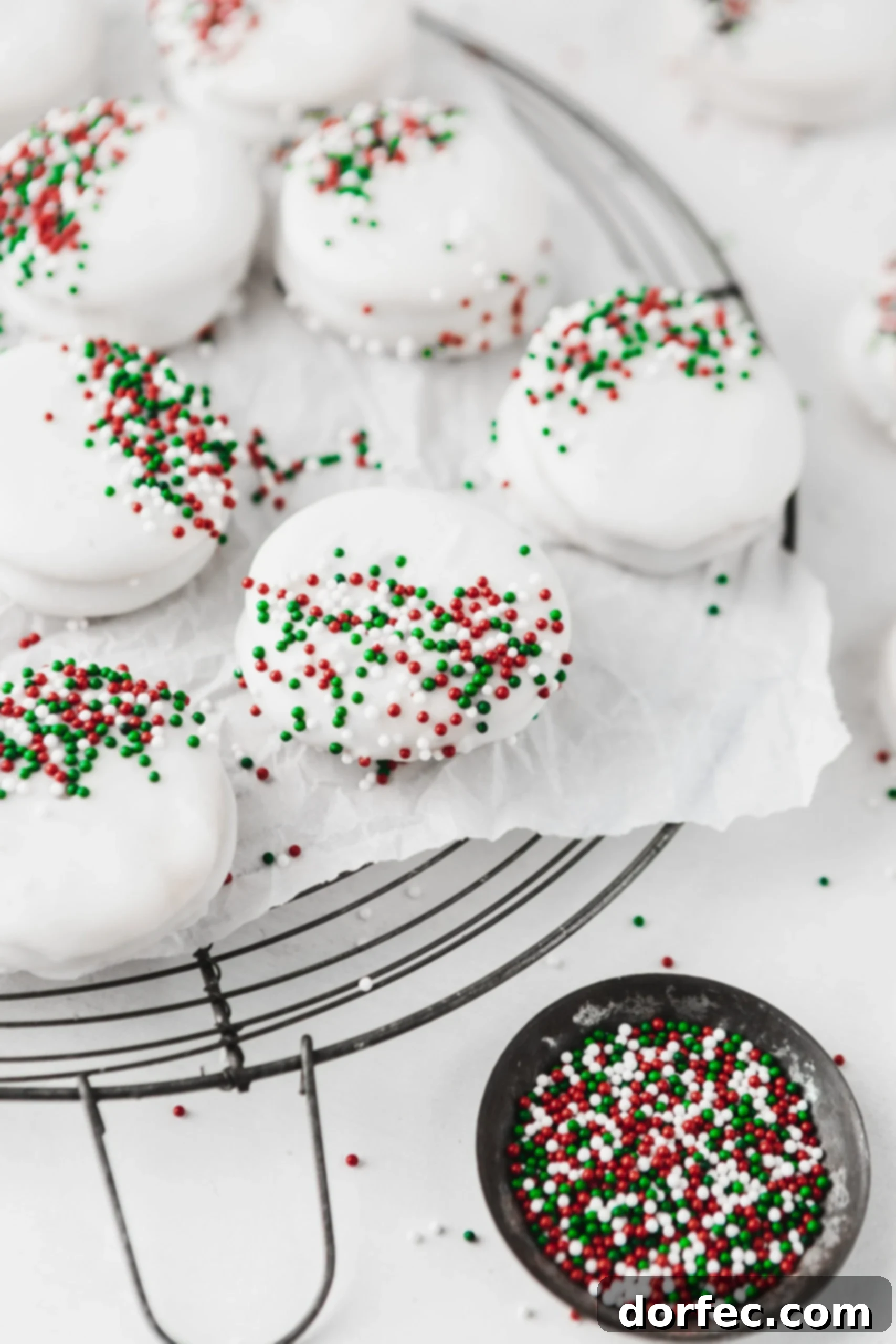 Peanut butter filled Ritz crackers with white chocolate coating, ready for festive sprinkles