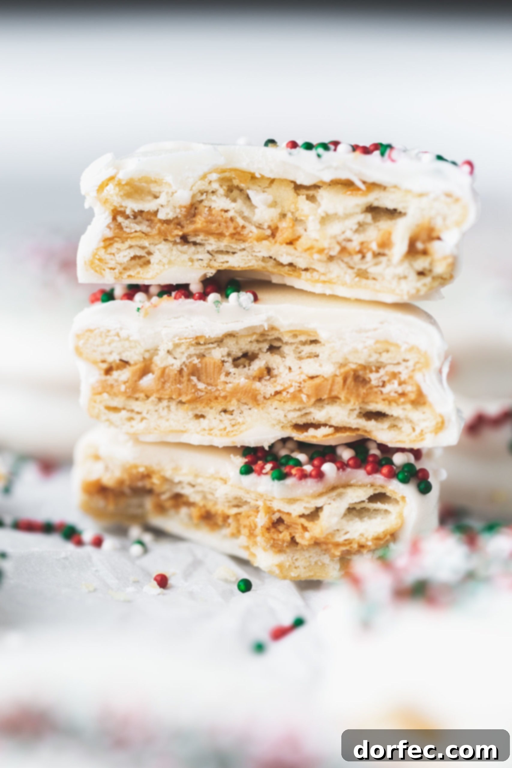 The easiest kid-friendly holiday candy to make: peanut butter filled Ritz crackers dipped in luscious white chocolate and adorned with festive sprinkles!