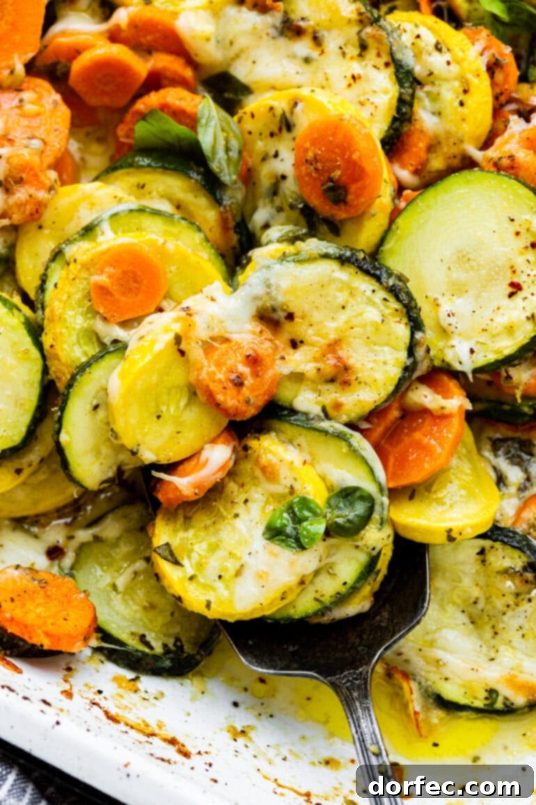 a closeup photo of melted cheese covered roasted vegetables