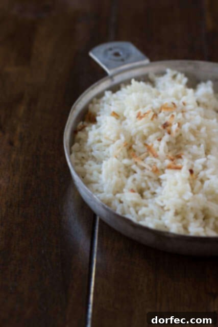 Sweet and sticky coconut rice, beautifully plated and ready to complement any meal, highlighting its irresistible texture.