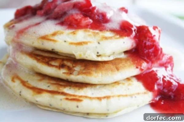 Close-up of a stack of soft and fluffy Meyer Lemon Poppy Seed Pancakes