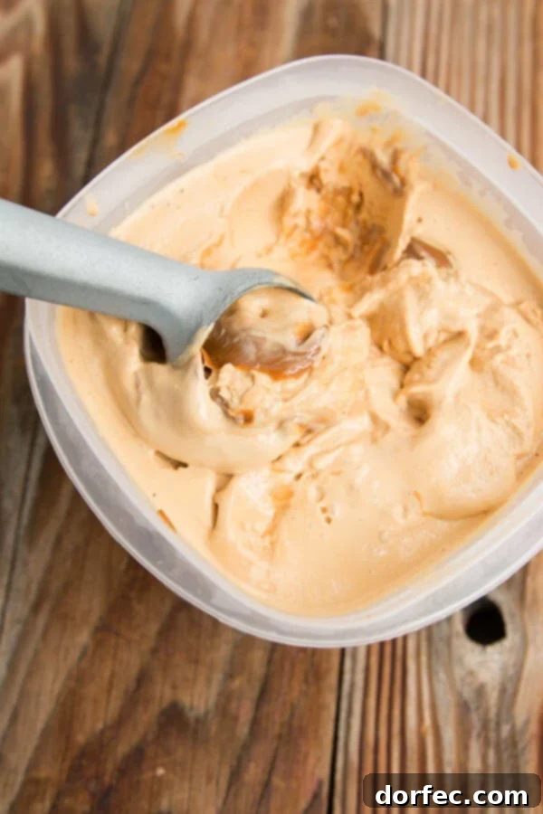 Scoops of golden dulce de leche ice cream in a serving bowl, perfectly churned.