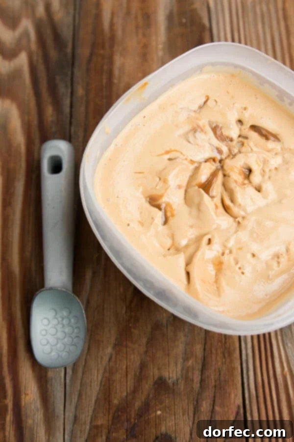 A large bowl of homemade dulce de leche ice cream with a spoon.