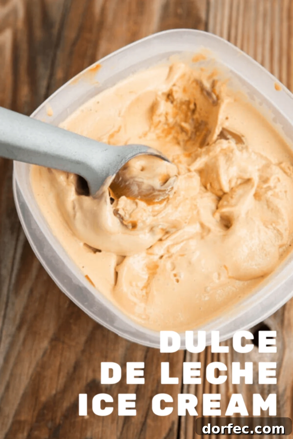 A bowl of ice cream swirled with dulce de leche, garnished with extra sauce.