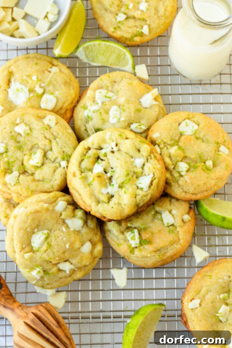 a photo of several perfectly golden baked cookies loaded with white chocolate chunks and lime zest
