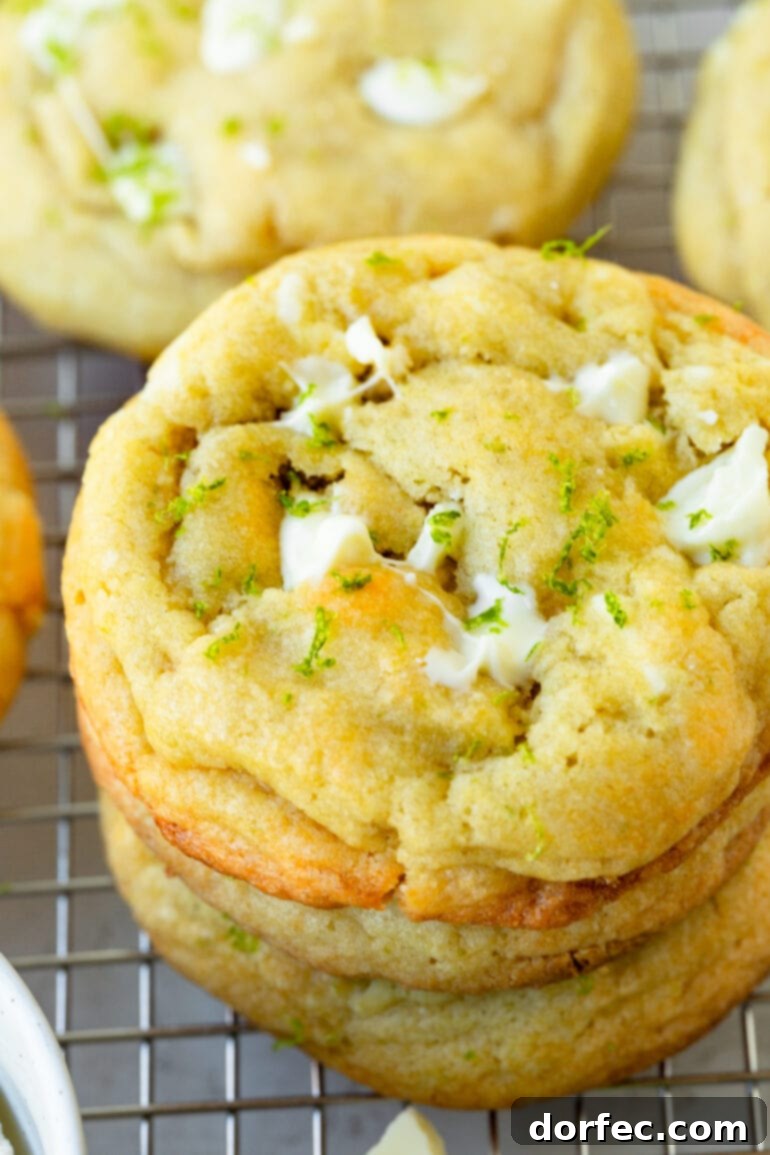 a close up of a stack of white chocolate lime cookies sitting on a wire cooling rack