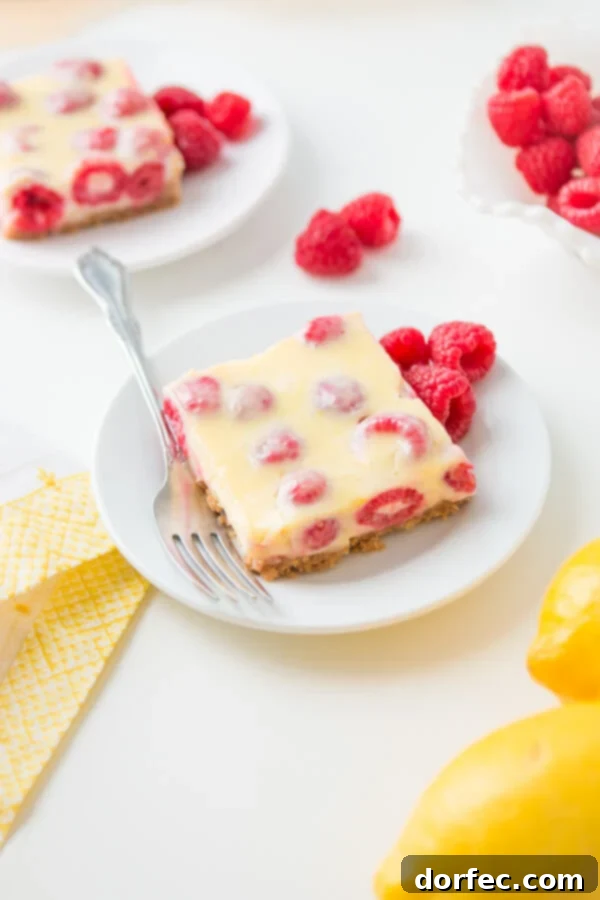 Lemon Raspberry Bars with a buttery graham cracker crust!