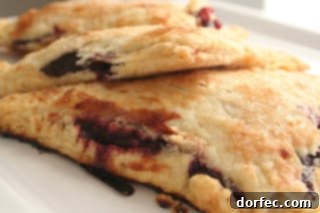 Delicious individual blackberry hand pies with a flaky golden crust, bursting with fresh berry filling, perfect for a Father's Day dessert.