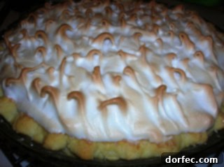 Father's Day Dessert Menu 5 A stunning lemon meringue pie with a tall, perfectly toasted golden meringue and a bright yellow citrus filling.
