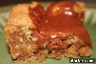 Homemade peanut butter bars with a smooth chocolate topping, cut into neat squares, offering a perfect blend of sweet and salty flavors.