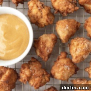 A top-down view of golden Chick-Fil-A style chicken nuggets and a bowl of the signature sauce.