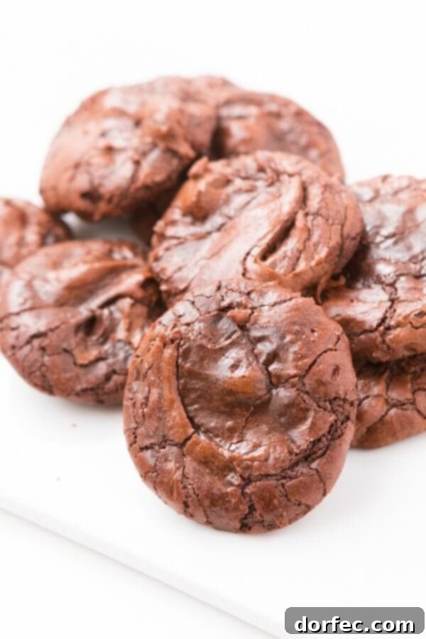 Stack of rich, dark, and perfectly baked Better Than Brownies Cookies on a cooling rack