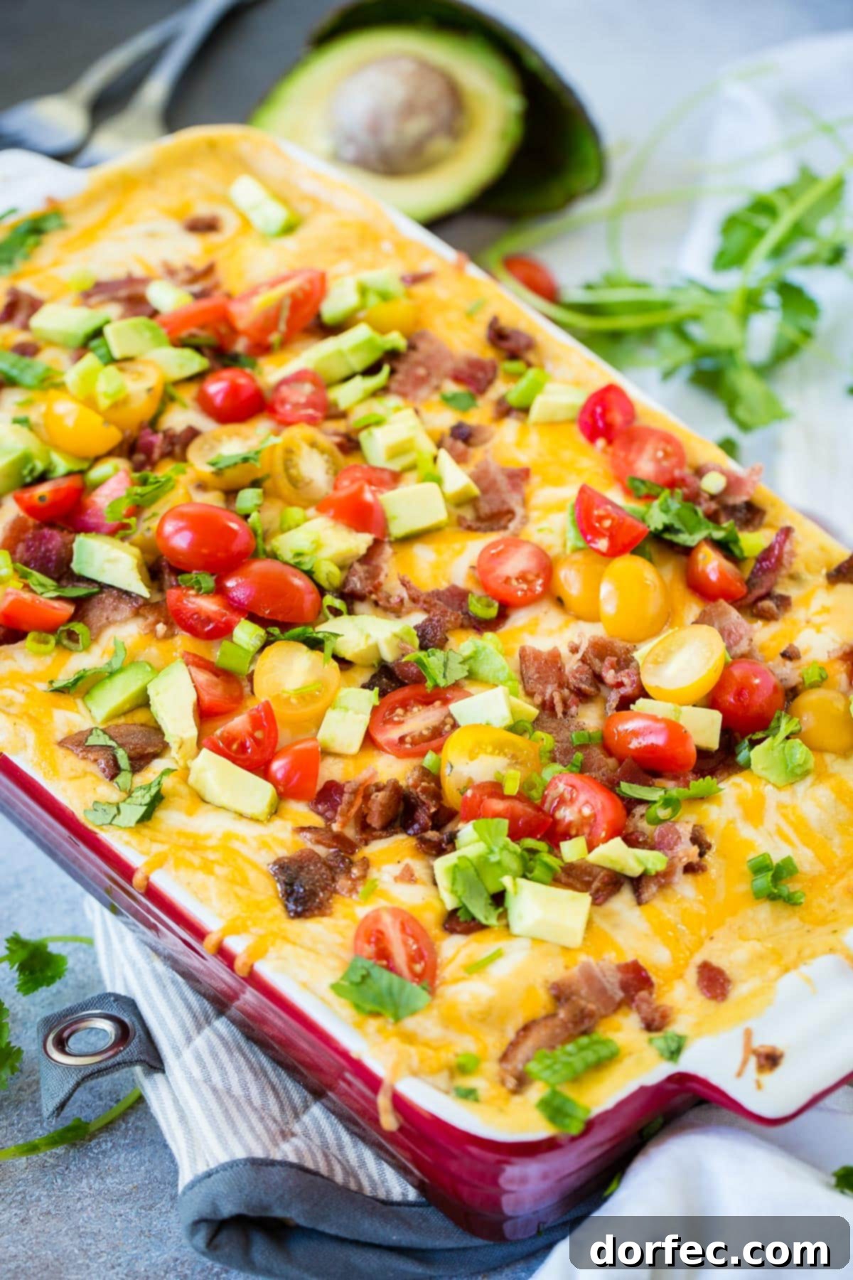 Need breakfast recipes to feed a crowd? Try this cheesy salsa verde sausage breakfast enchiladas recipe ohsweetbasil.com