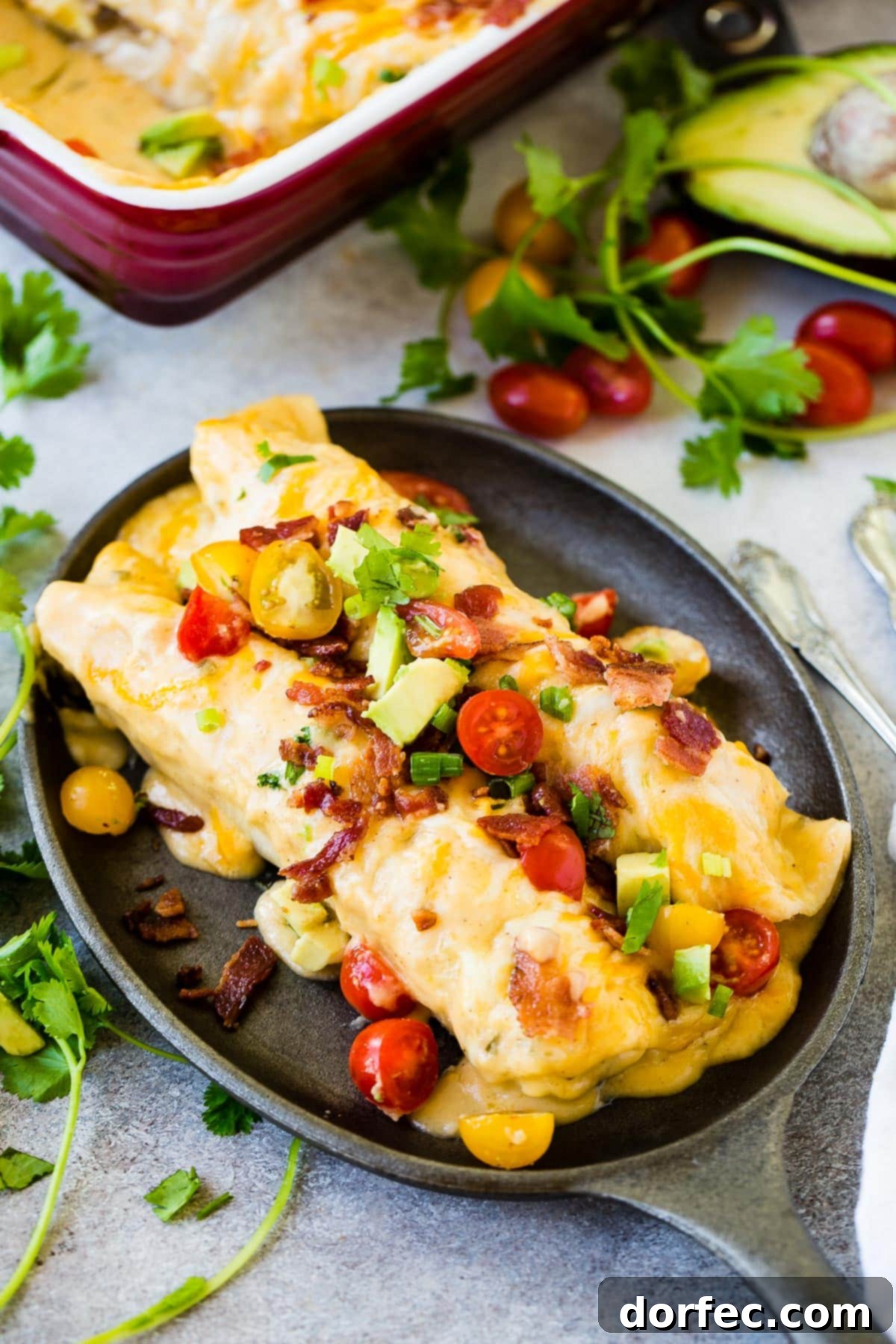 Cheesy breakfast enchiladas with fluffy scrambled eggs, sausage, bacon and a killer cheese sauce! ohsweetbasil.com 