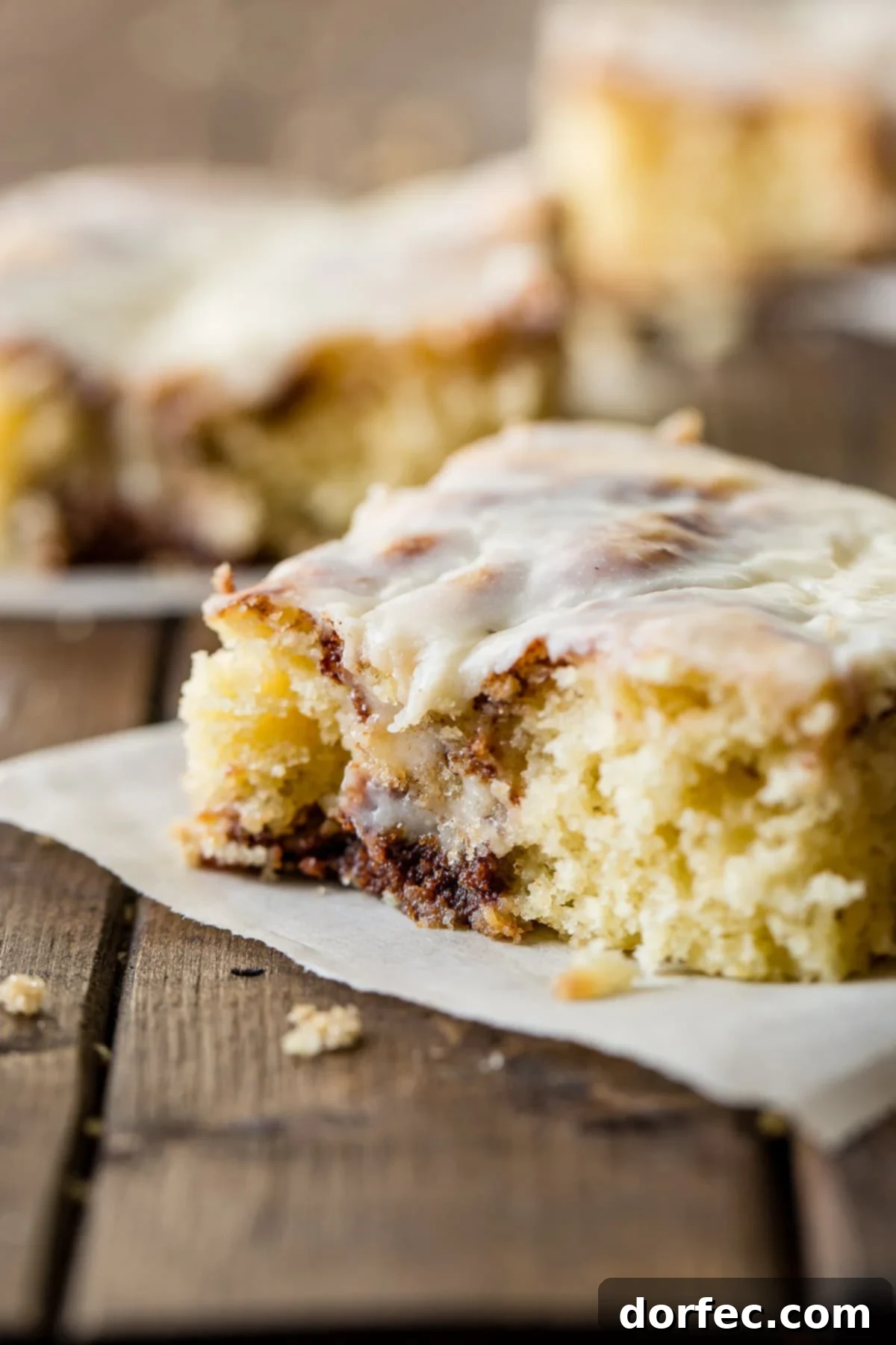 Decadent Cinnabon Cinnamon Roll Sheet Cake with a rich, cooked vanilla cream cheese frosting, perfect for sharing.