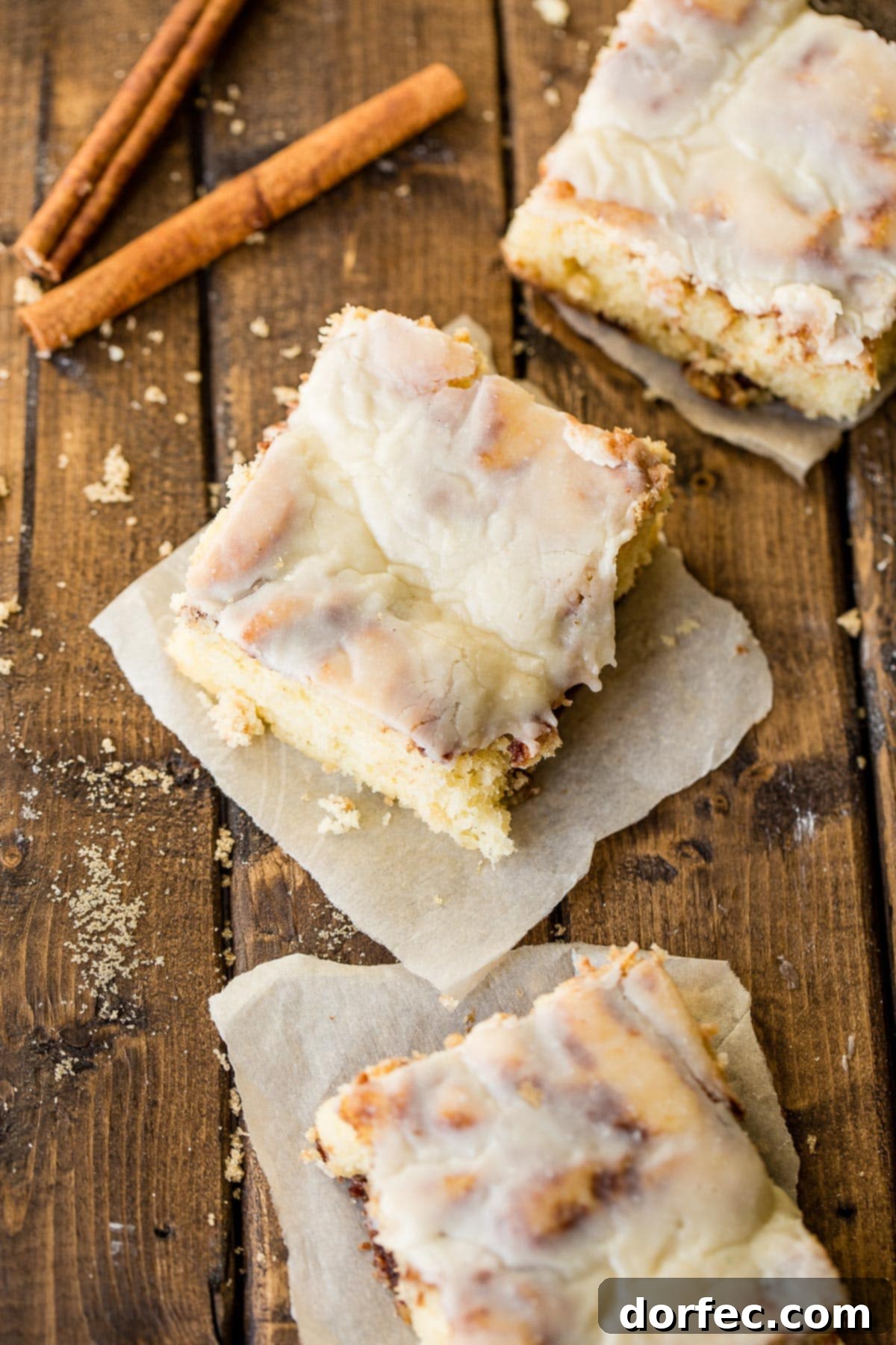 The perfect slice of Cinnabon Cinnamon Roll Sheet Cake, revealing layers of soft cake and cinnamon goodness.
