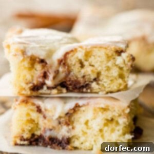 Cinnabon Cinnamon Roll Sheet Cake with cooked vanilla cream cheese frosting