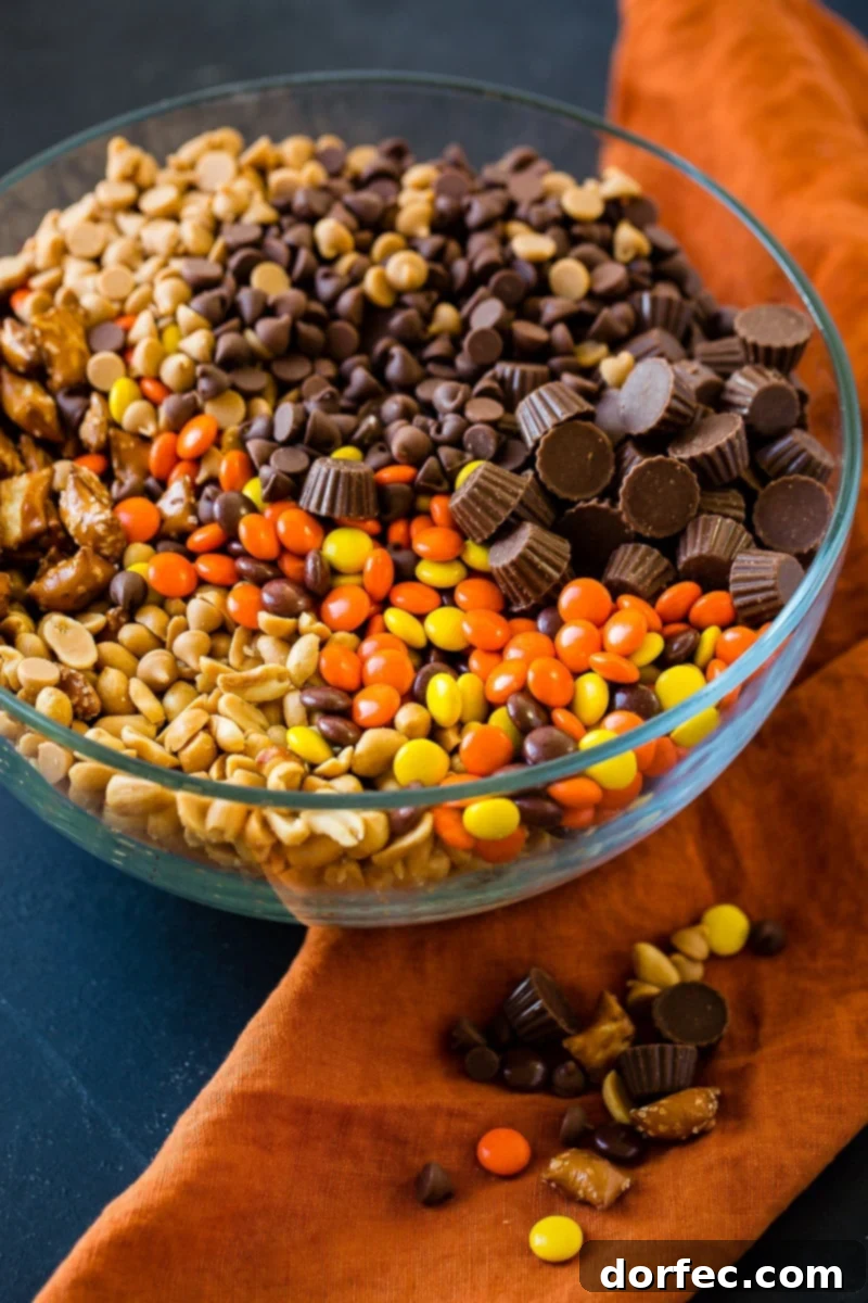 A festive bowl of Reese's Snack Mix featuring pretzels, peanuts, and various Reese's candies, ready for a holiday gathering.