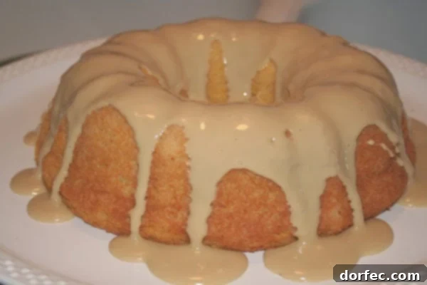 Spiced Pumpkin Angel Cake 2 Delicious slice of Pumpkin Angel Food Cake with a drizzle of maple glaze, perfect for fall desserts.