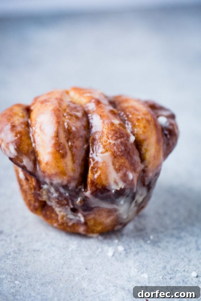 Pillowy Maple Glazed Cinnamon Butterflake Rolls 4 Up close of a maple glaze cinnamon butterflake roll