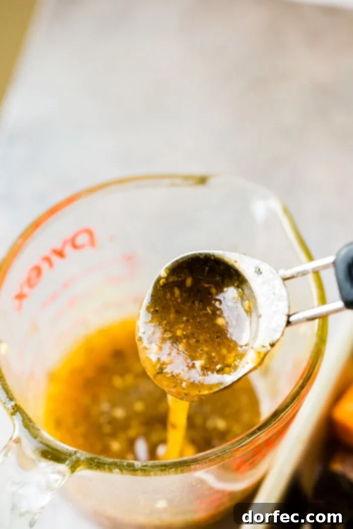 Small measuring cup filled with amber honey garlic sauce