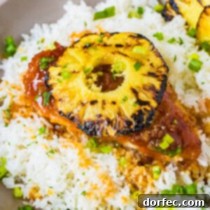 Sweet and Sticky Pineapple Chicken Dinner 8 A beautifully presented Candied Chicken dish with grilled pineapple, served over rice. Perfect for a quick and flavorful 30-minute dinner.