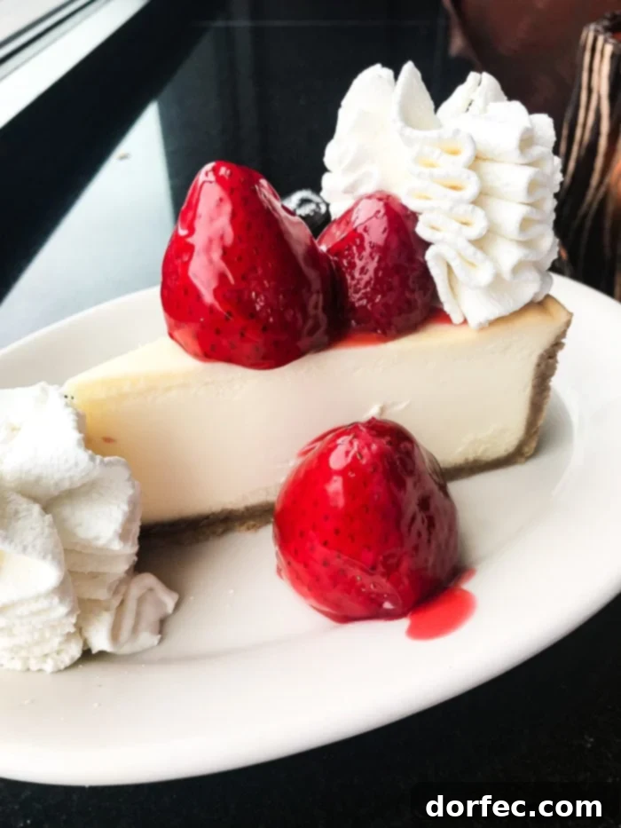 Close-up of a slice of Strawberry Cheesecake at The Cheesecake Factory, highlighting its fresh fruit topping and creamy texture.