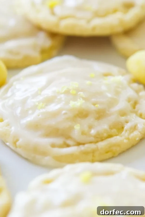 Soft and chewy lemon drop cookies with a light glaze and crushed lemon drops on top. ohsweetbasil.com