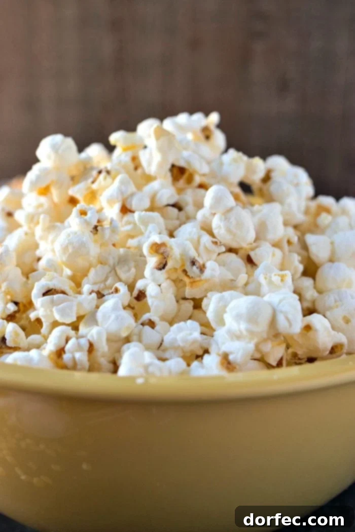 A big yellow bowl of fluffy and light Salt & Vinegar popcorn.