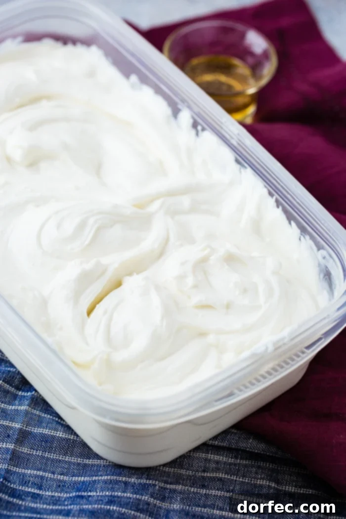 Creamy Instant Pot Yogurt 4 instant pot Homemade yogurt in a tupper ware container with a small serving of honey
