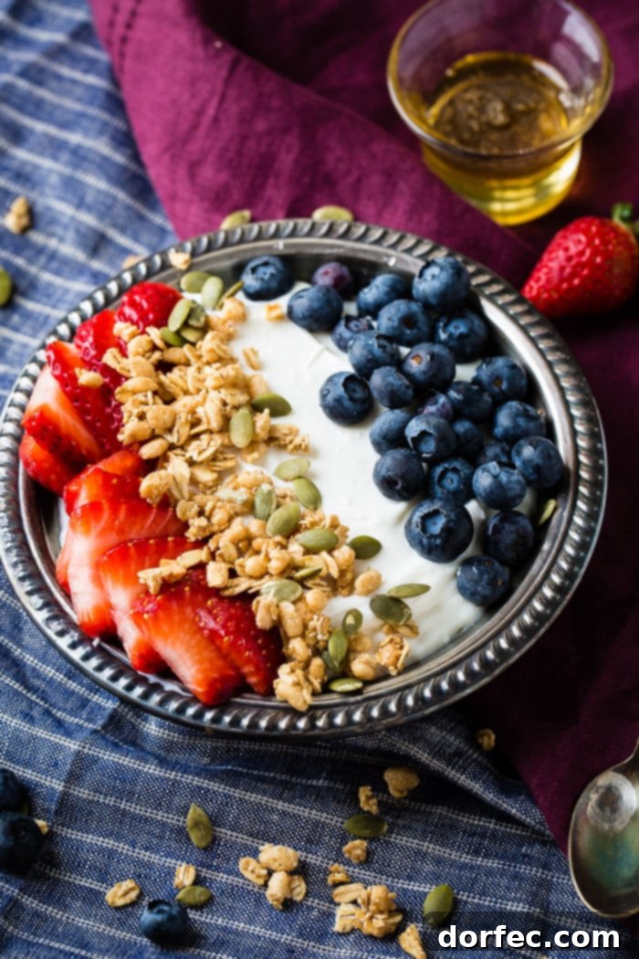 Creamy Instant Pot Yogurt 5 Instant pot homemade yogurt in a vintage bowl with a drizzle of honey and granola with pepitas and fresh blueberries and sliced strawberries for a healthy breakfast recipe