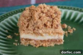 Zesty Lime Squares 2 Delicious Key Lime Crumble Bars on a white plate, showcasing the buttery graham cracker crust, creamy lime filling, and golden crumble topping.