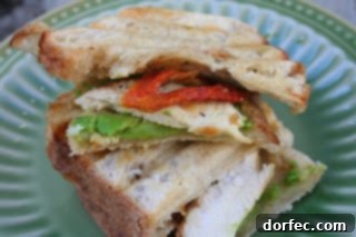 Signature Grilled Chicken Sandwich 2 Delicious grilled chicken sandwich with avocado and roasted red peppers on toasted sourdough bread