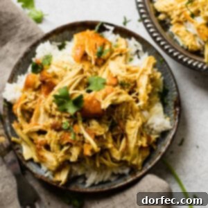 A metal, vintage bowl filled with white long grain rice and shredded chicken with a simple honey curry sauce made in an instant pot with cilantro on top. easy instant pot honey chicken