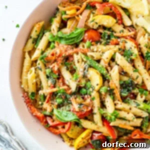 Vibrant Spring Pasta Primavera Recipe 8 A photo of a large bowl full of penne pasta tossed with vegetables and a creamy sauce, illustrating the delicious Pasta Primavera dish.