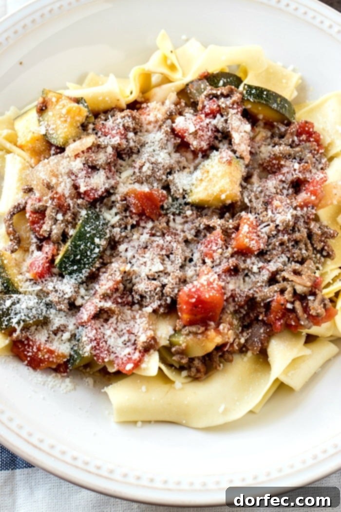 Rustic tomato sauce with chunks of meat and zucchini, ready to be served over pasta.