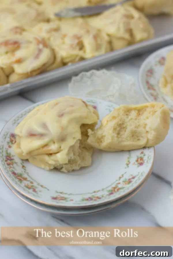 Freshly baked orange rolls with soft, fluffy texture, ready for a generous orange glaze. A perfect sweet treat for any occasion.