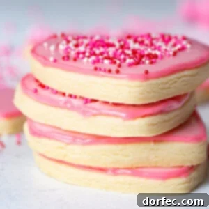 Beautifully decorated pink heart sugar cookies with sprinkles, perfect for any occasion.