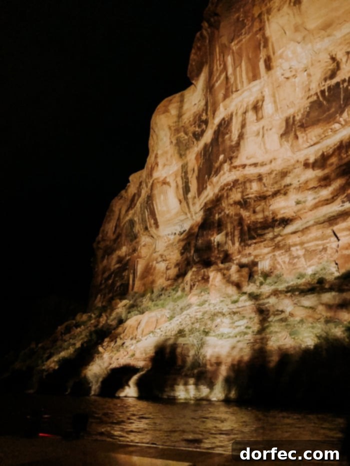 Illuminated red rock cliffs during the Moab Dinner Cruise light show