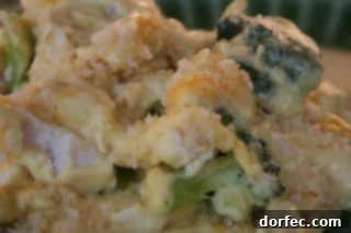 Creamy Chicken Curry Casserole being scooped from a baking dish