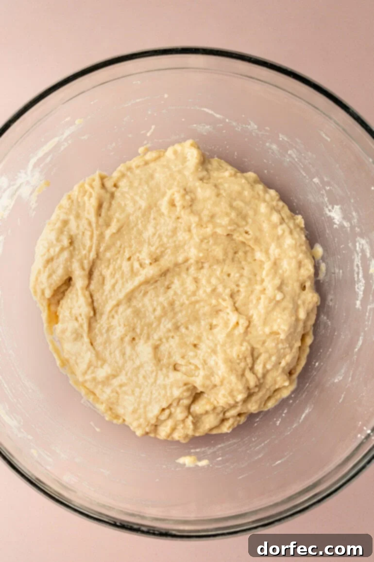 Bakery Style Chocolate Chip Muffins 6 Wet ingredients for chocolate chip muffins being whisked in a separate bowl.