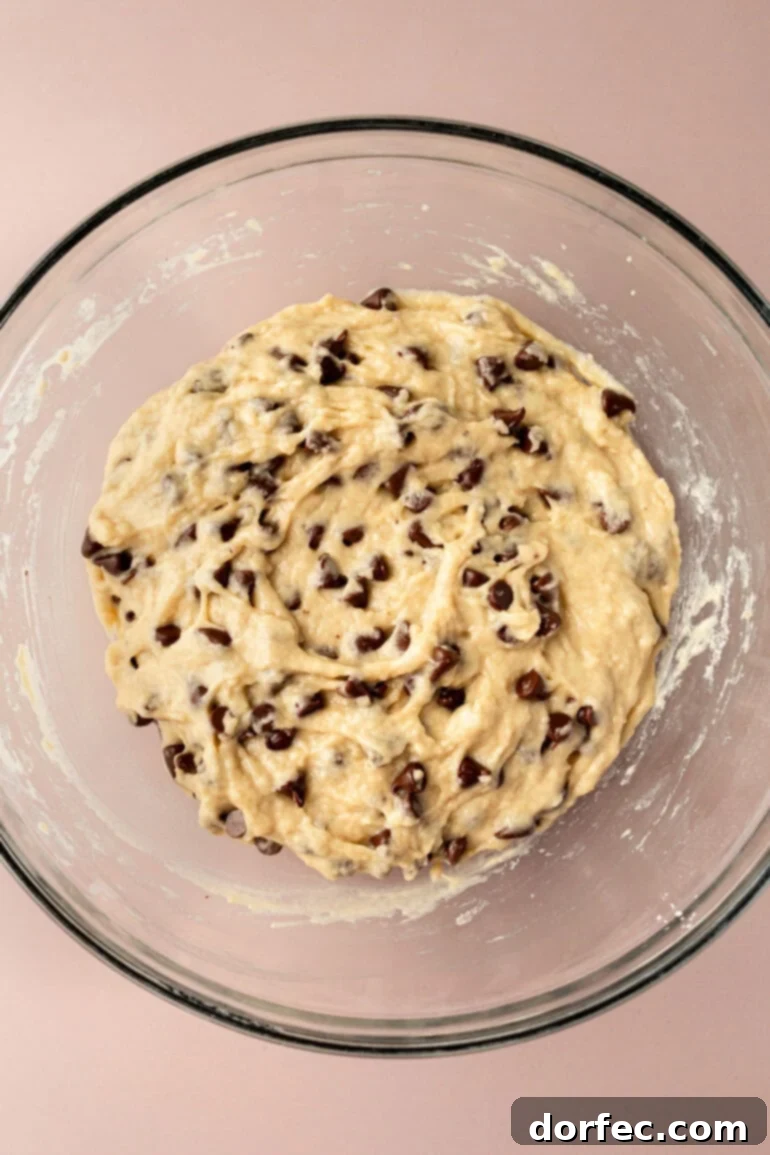 Bakery Style Chocolate Chip Muffins 7 Chocolate chips being gently folded into the muffin batter.