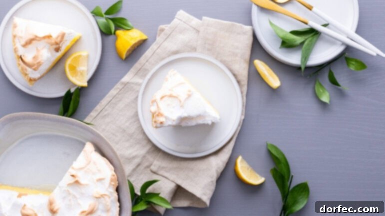 Family Recipe Lemon Meringue Pie 10 a photo taken over the top of a single slice of pie sitting on a white dessert plate